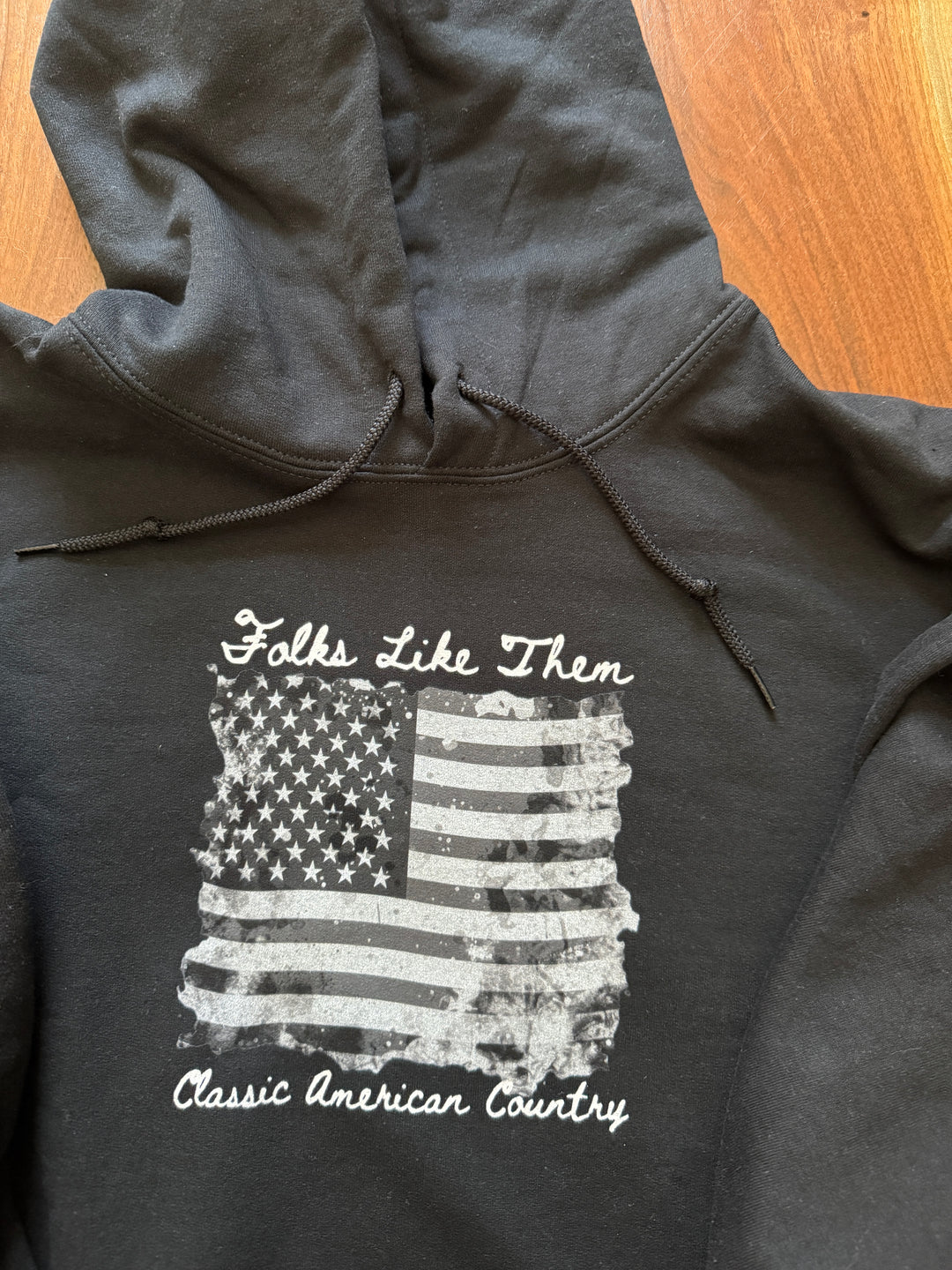 Black hoodie featuring distressed American flag and 'Classic American Country' text, perfect for country music fans.